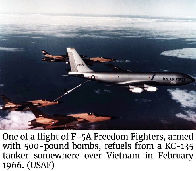 Photo of one of a flight of F-5A Freedom Fighter, armed with 500-pound bombs, refuels from a KC-135 tanker somewhere over Vietnam in February 1966. (USAF)